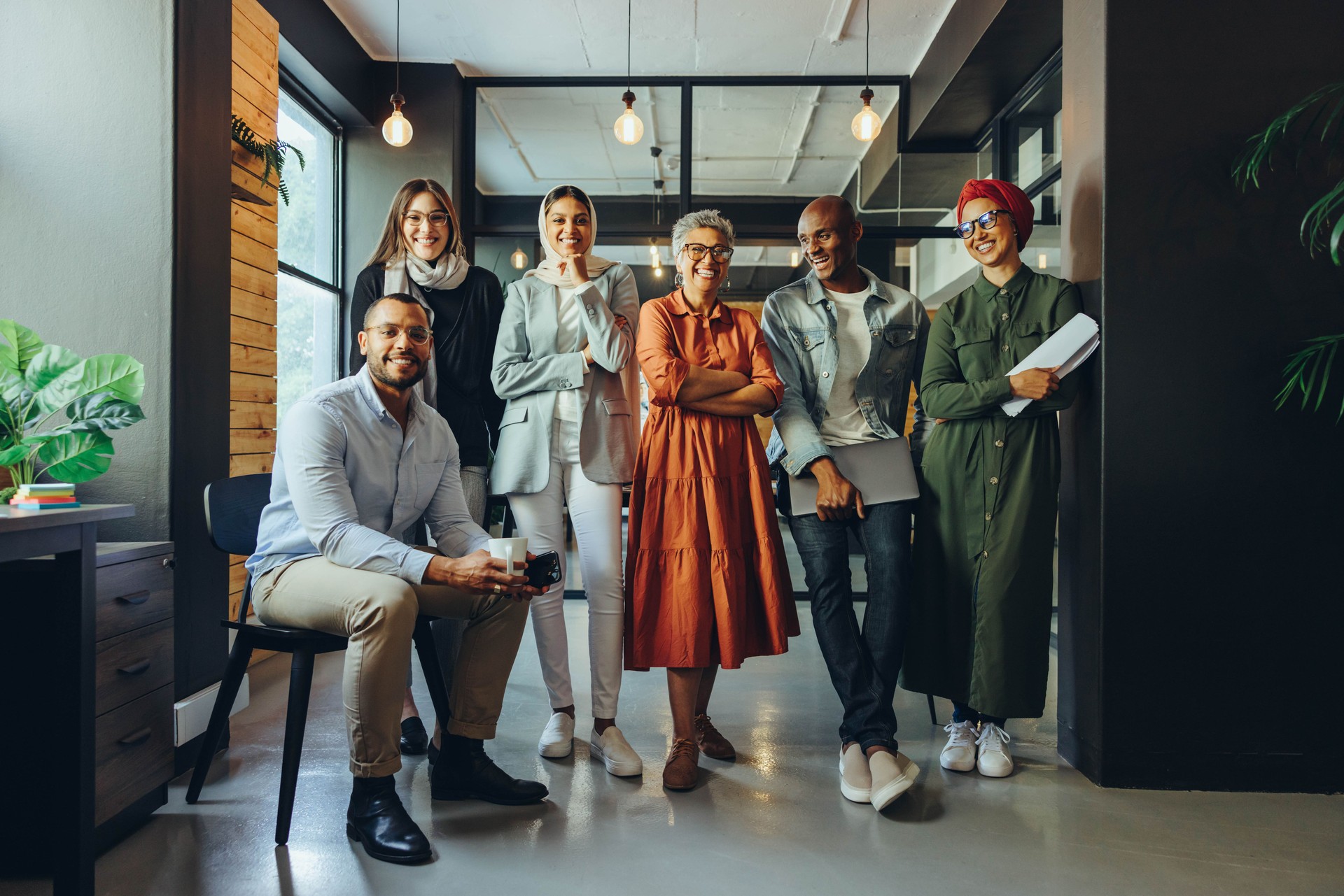 Successful business team smiling at the camera in an office